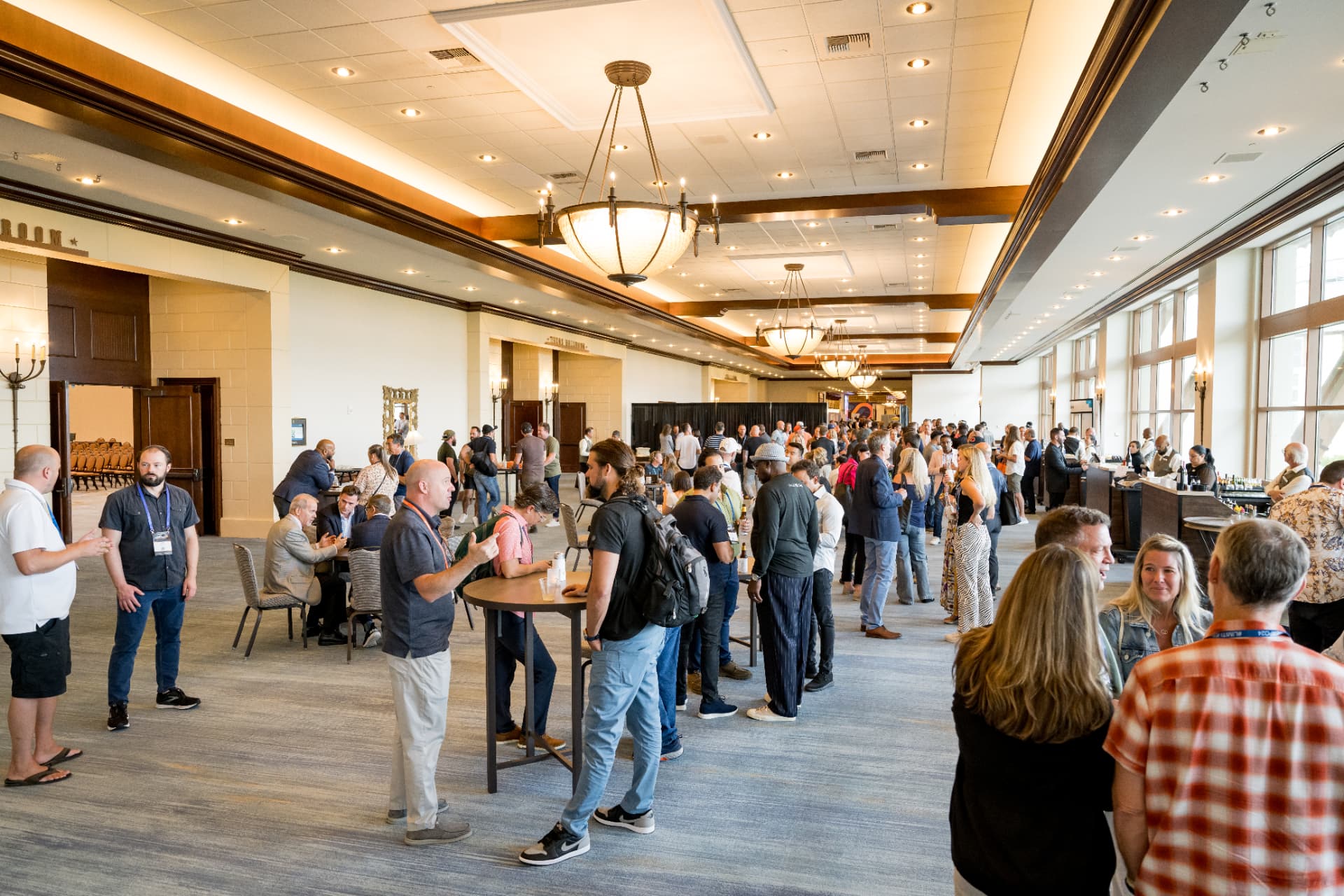 Attendees mingling in the concourse during a Limitless Expo break