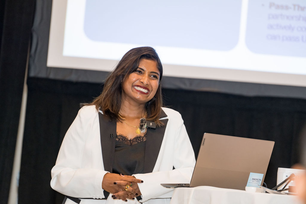 Panelist laughing behind a laptop during a Limitless Expo breakout session