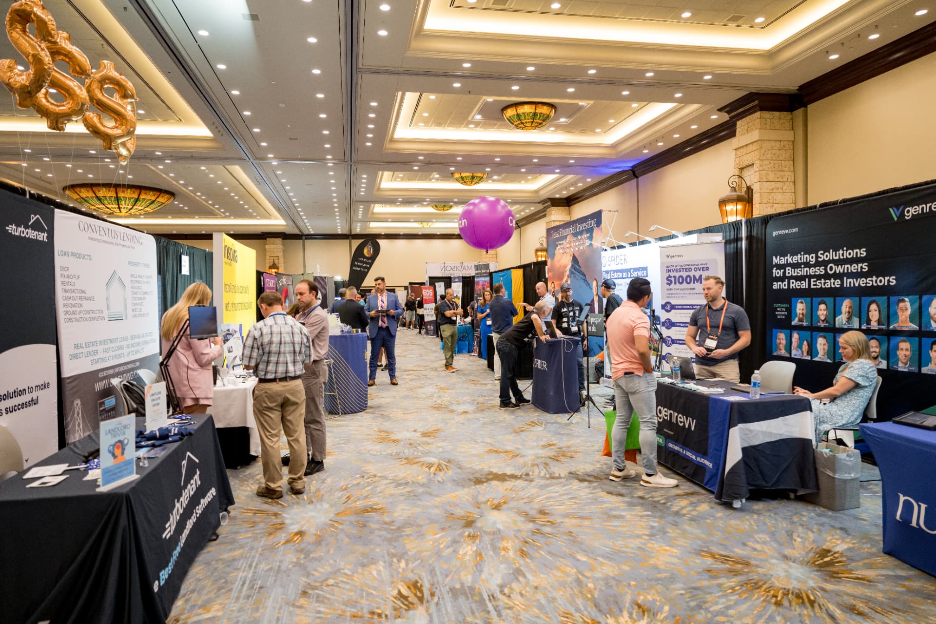 Aisle view of exhibitor booths in the Limitless Expo hall