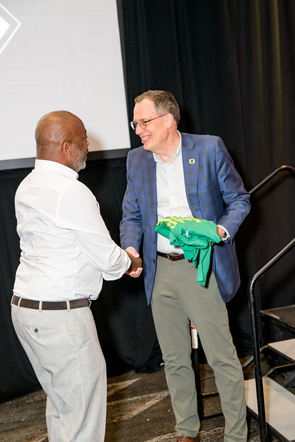 Handshake and jersey presentation on stage at the BSA Summit