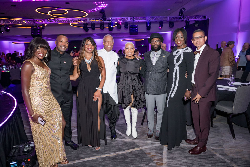 Group of guests posing together on the ballroom floor
