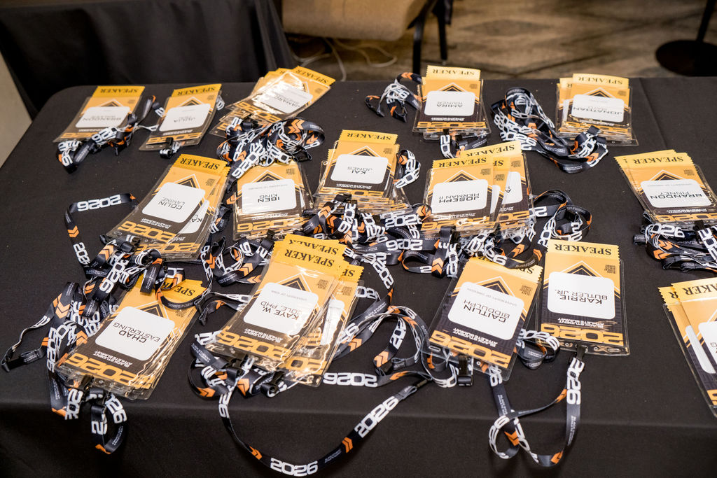 Speaker credentials and lanyards laid out at check-in