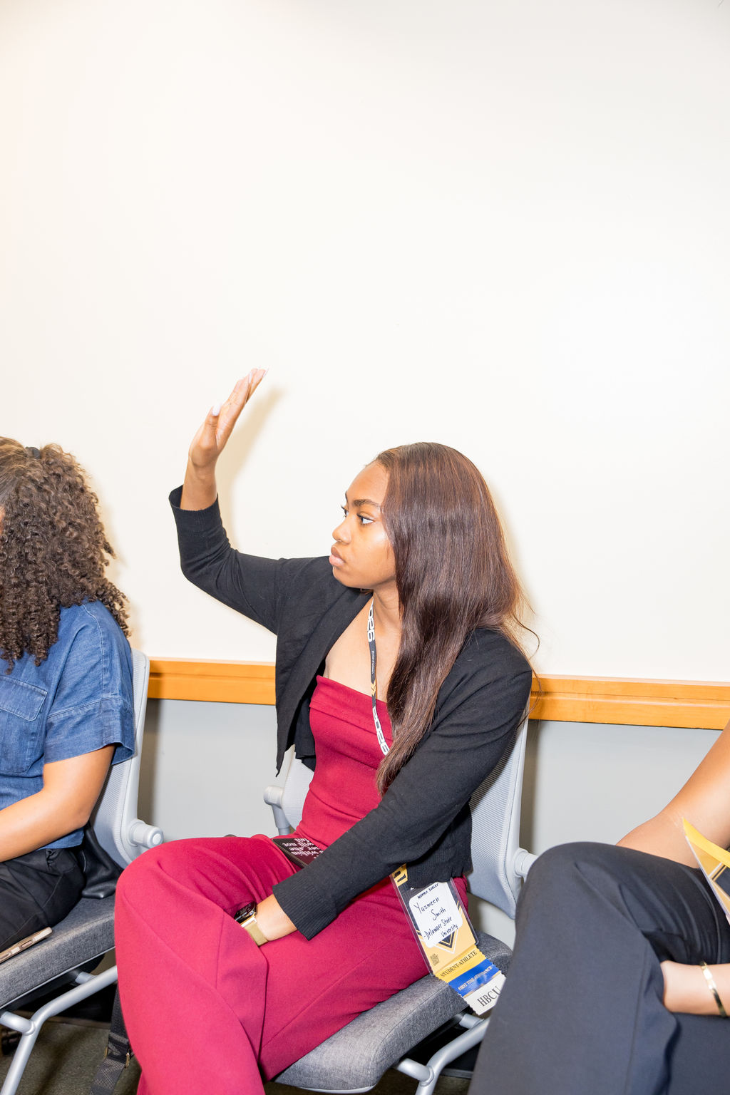 Student-athlete raising her hand during a session