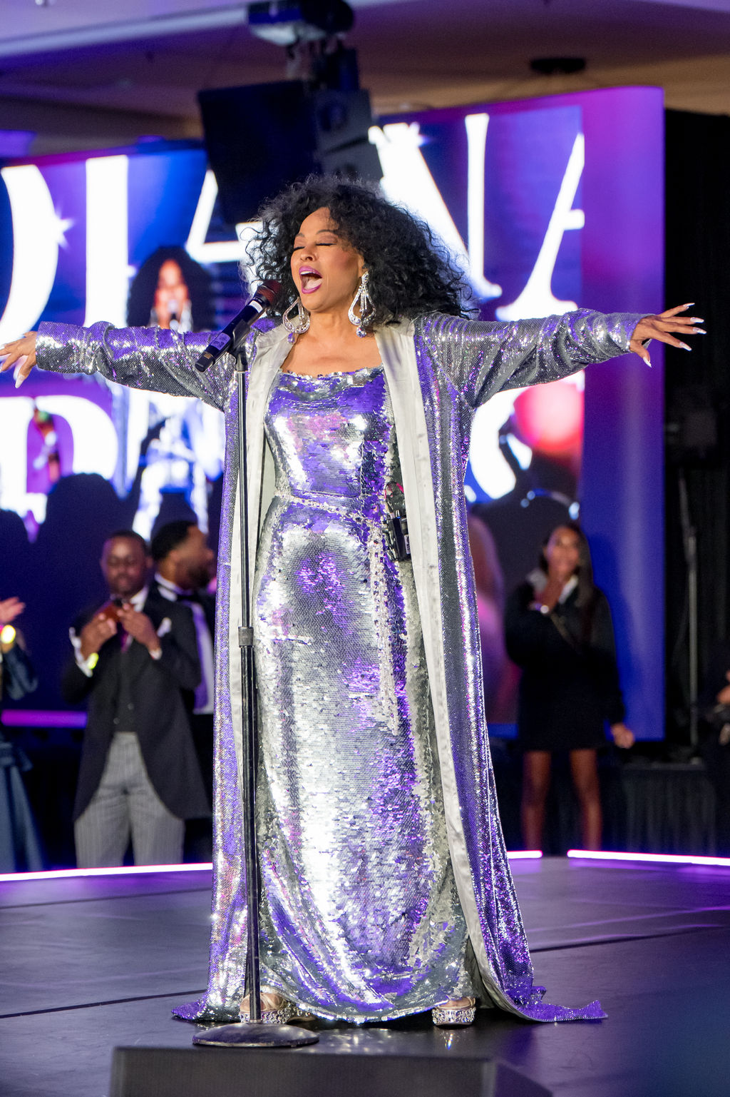 Performer with arms outstretched during the finale