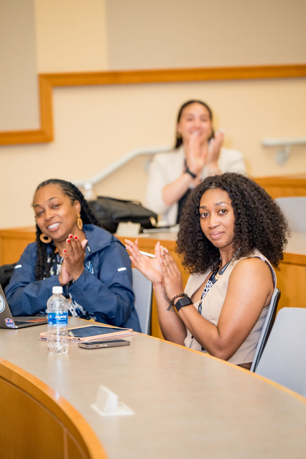 Attendees applauding during a roundtable session