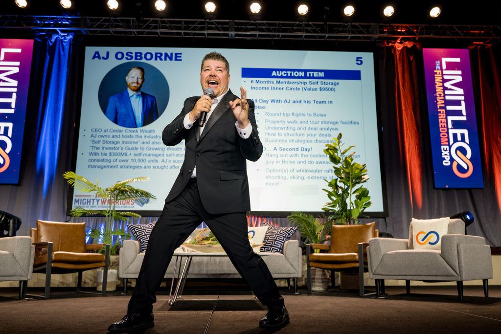 Energetic auctioneer on stage during the Limitless Expo auction