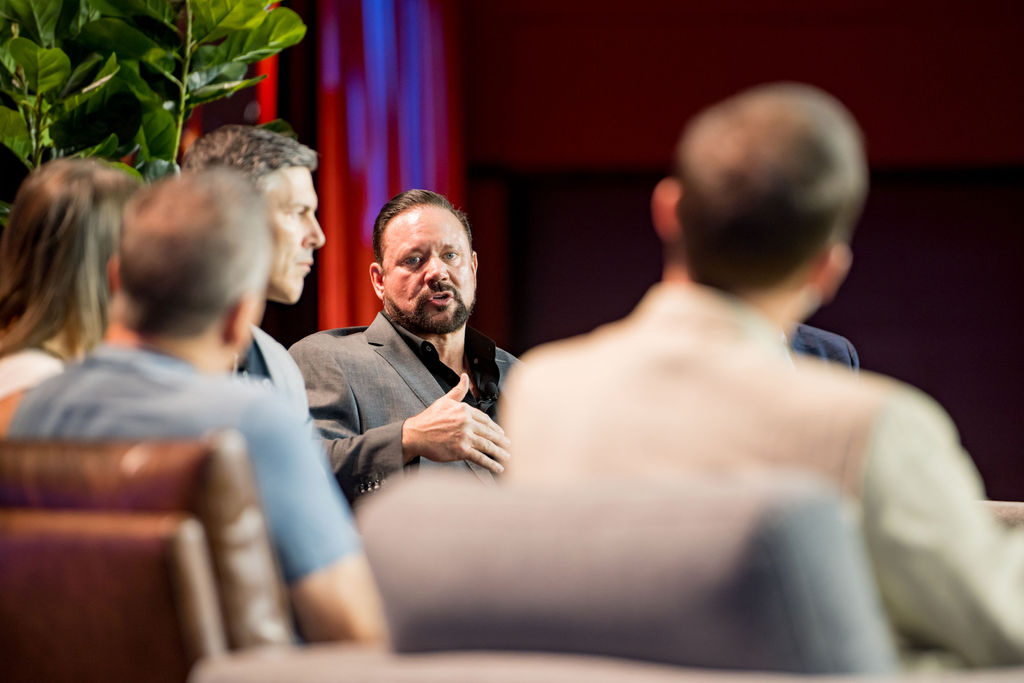Panelist making a point during a fireside chat at Limitless Expo