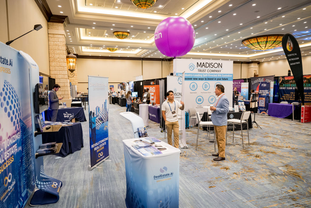 Exhibitors and attendees networking in the Limitless Expo exhibitor hall