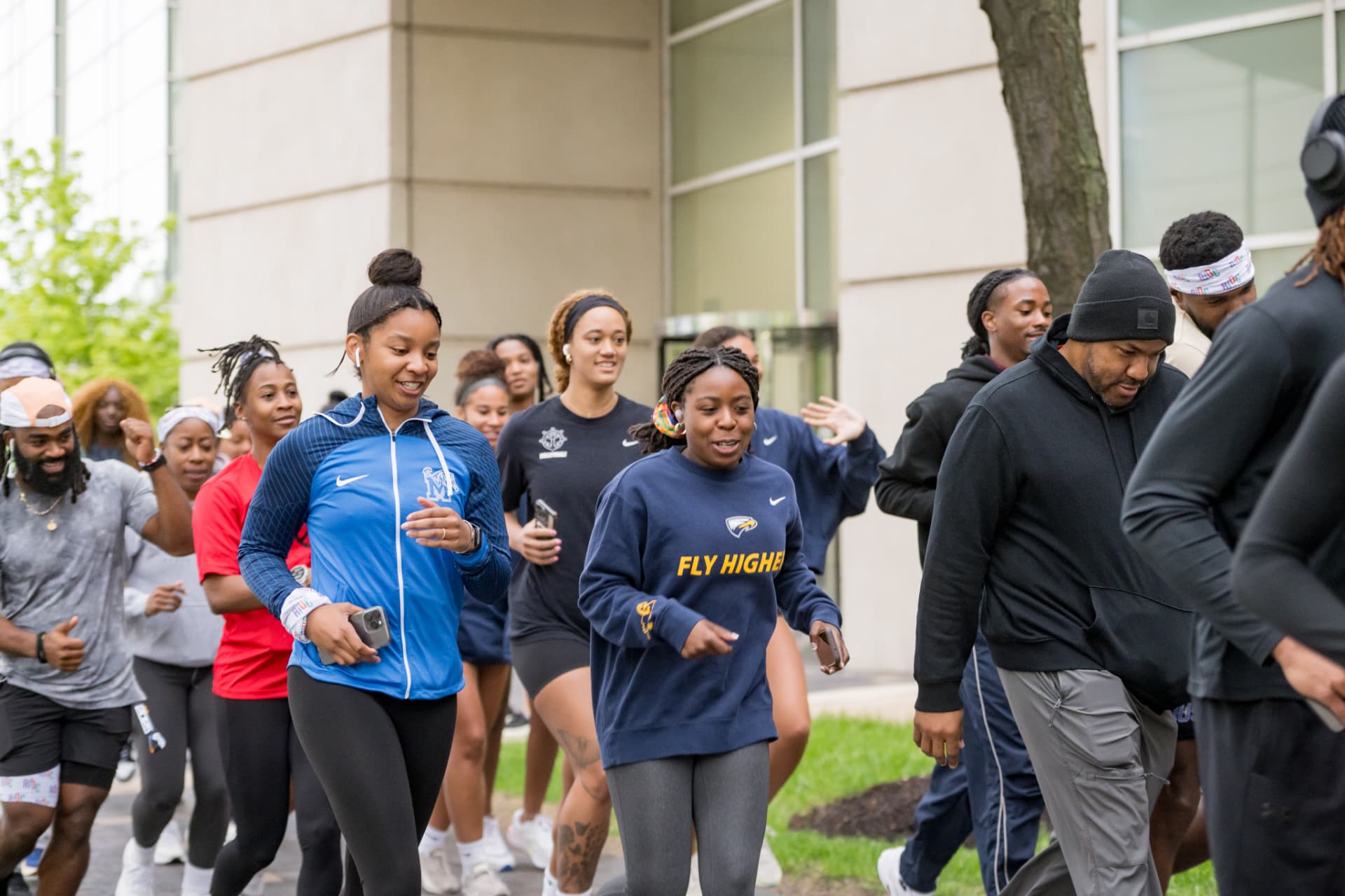 Smiling participants running together outdoors