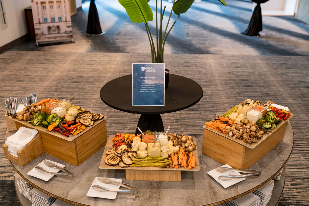 Catered grazing station styled beneath TMRS branded signage