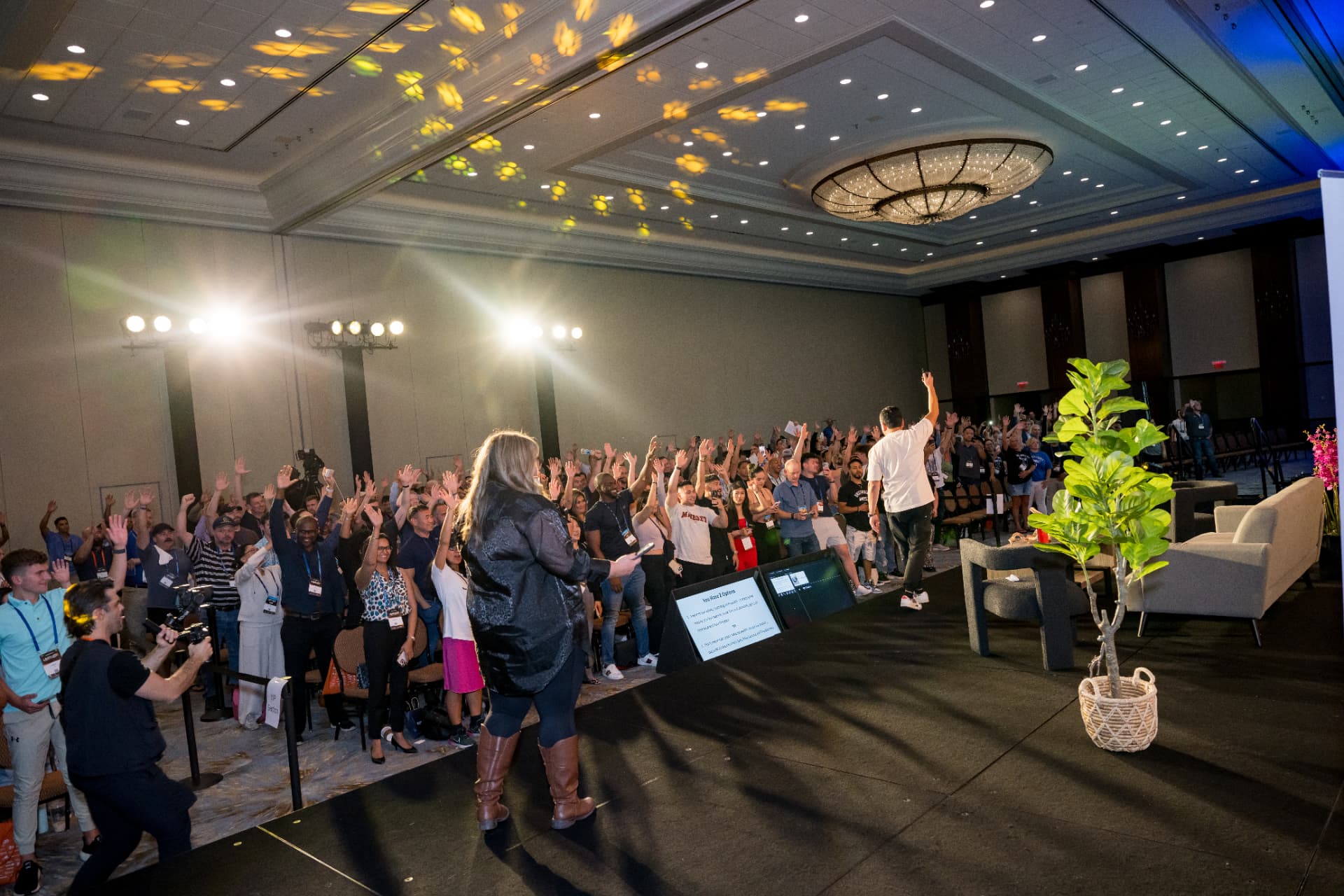 Attendees raising their hands during an interactive Limitless Expo session