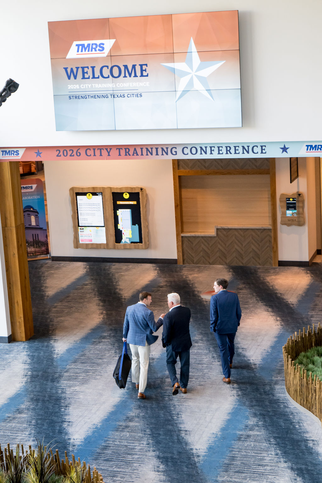 Attendees arriving under the 2026 TMRS City Training Conference welcome signage