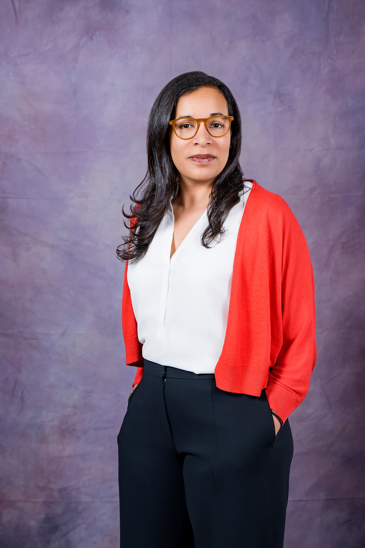 Studio portrait of a professional woman in a red cardigan and white blouse