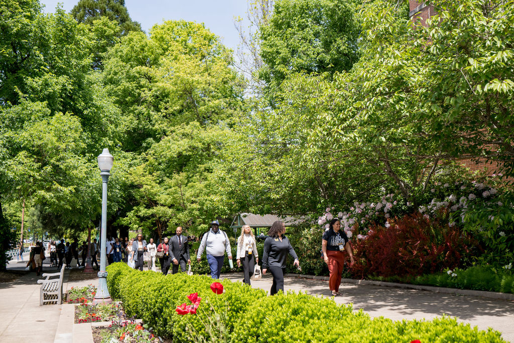 Attendees walking the University of Oregon campus between sessions