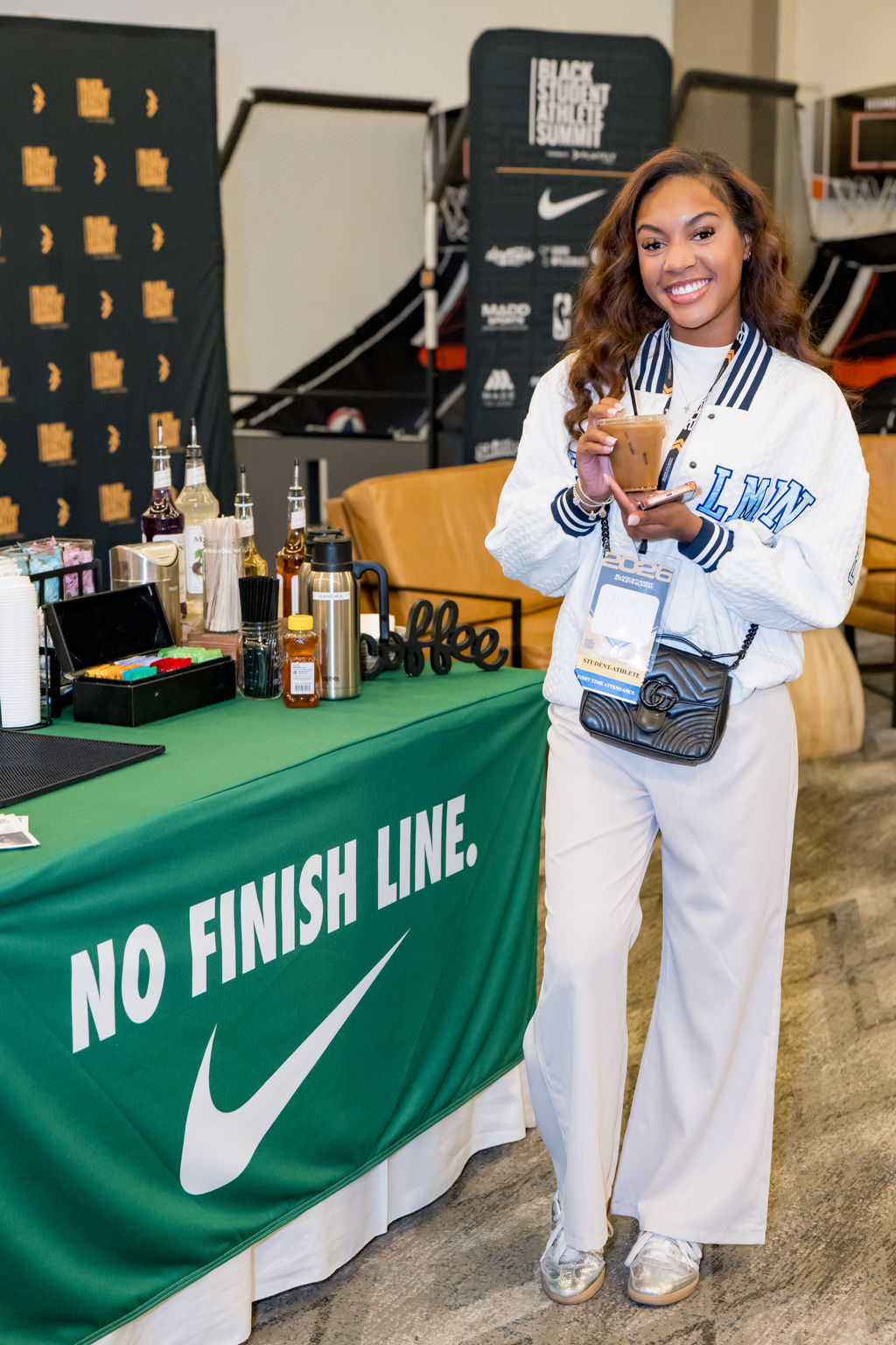 Attendee with an iced coffee at the Nike sponsor lounge