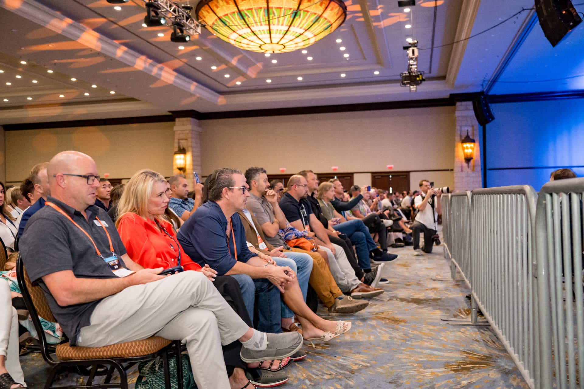 Front-row attendees watching a presentation at Limitless Expo