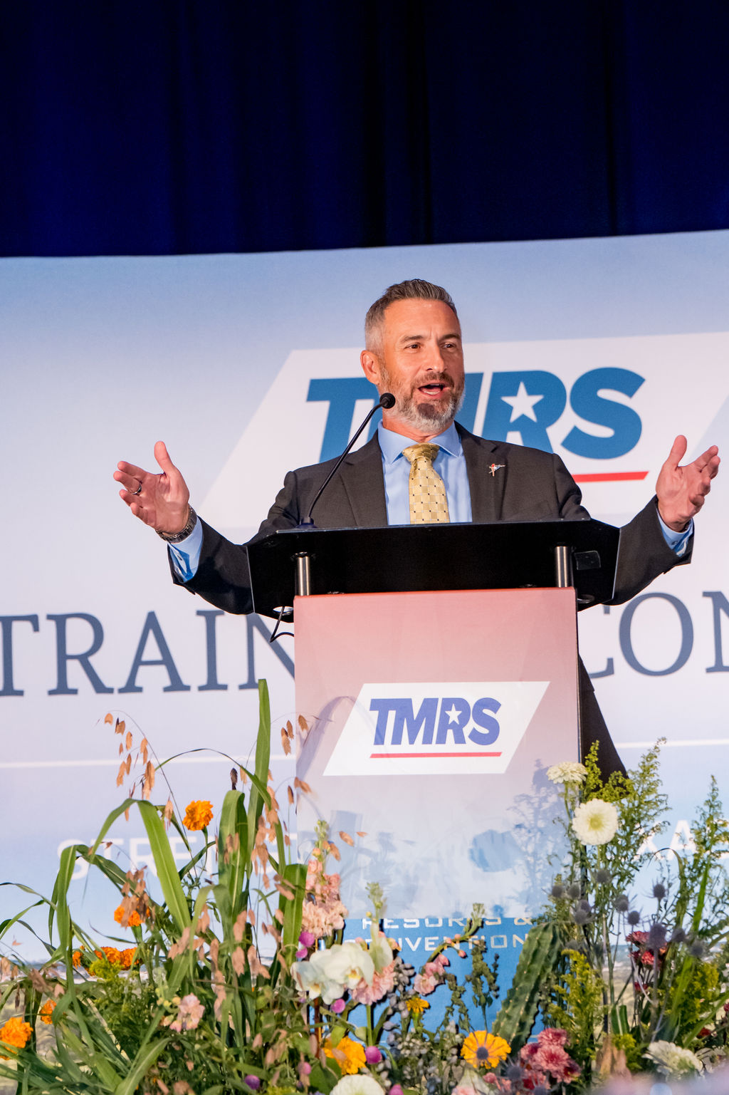 Keynote speaker addressing the room from the TMRS podium