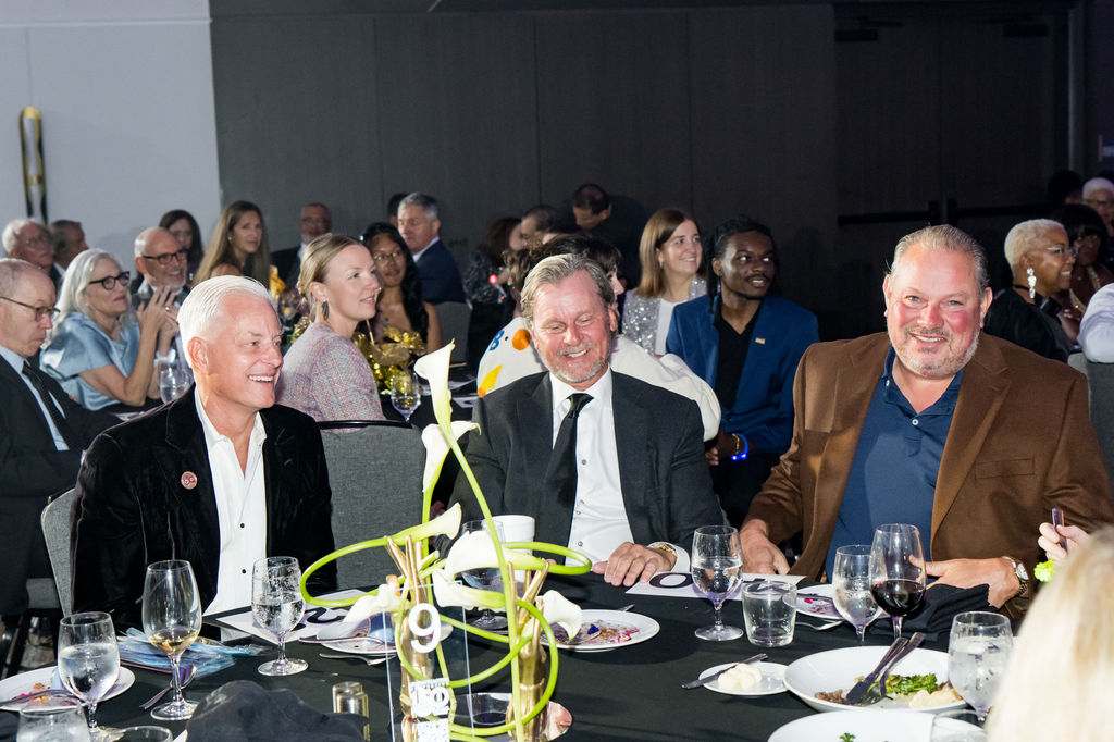 Table of guests laughing during the program