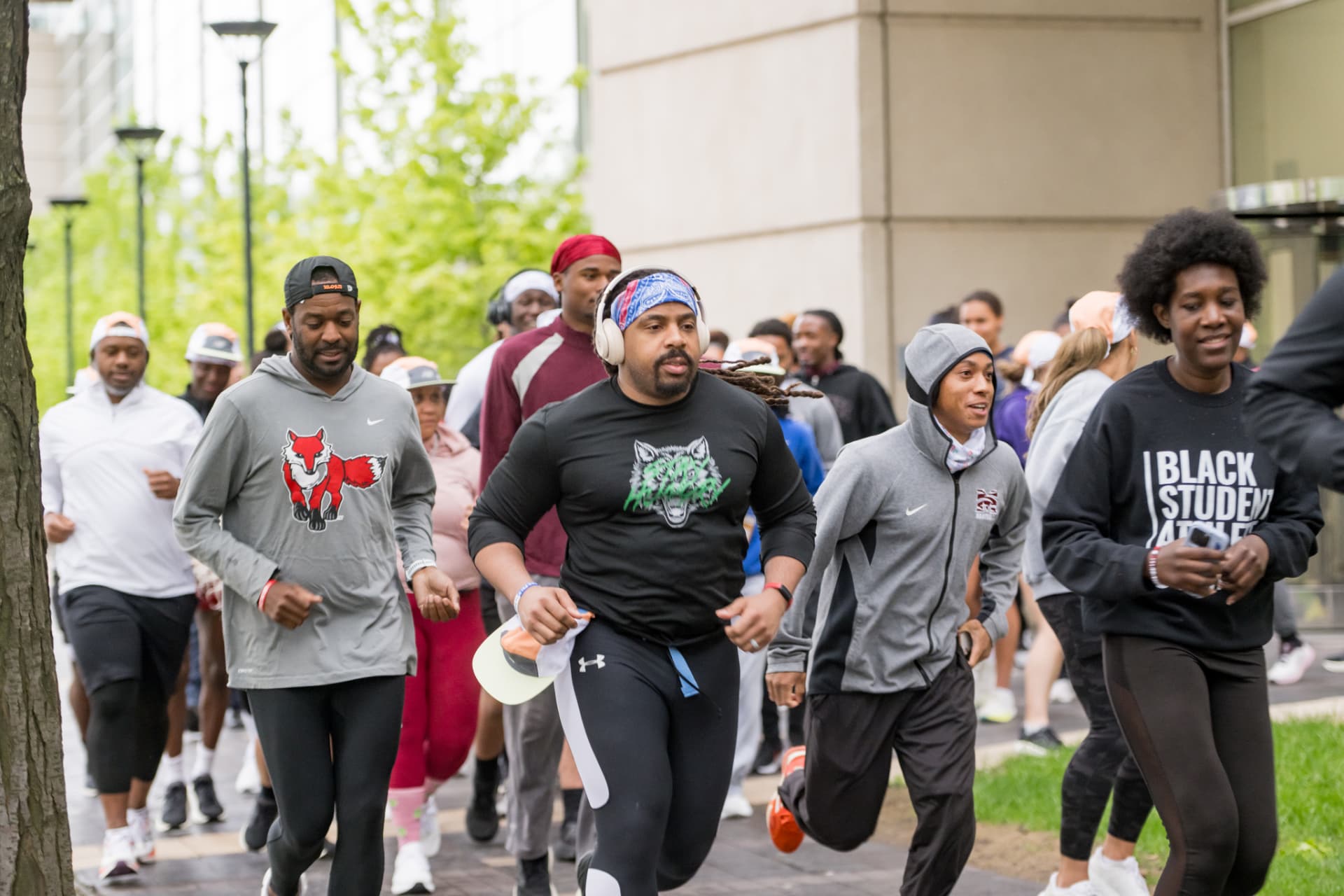 Runners jogging along a sidewalk during the morning run