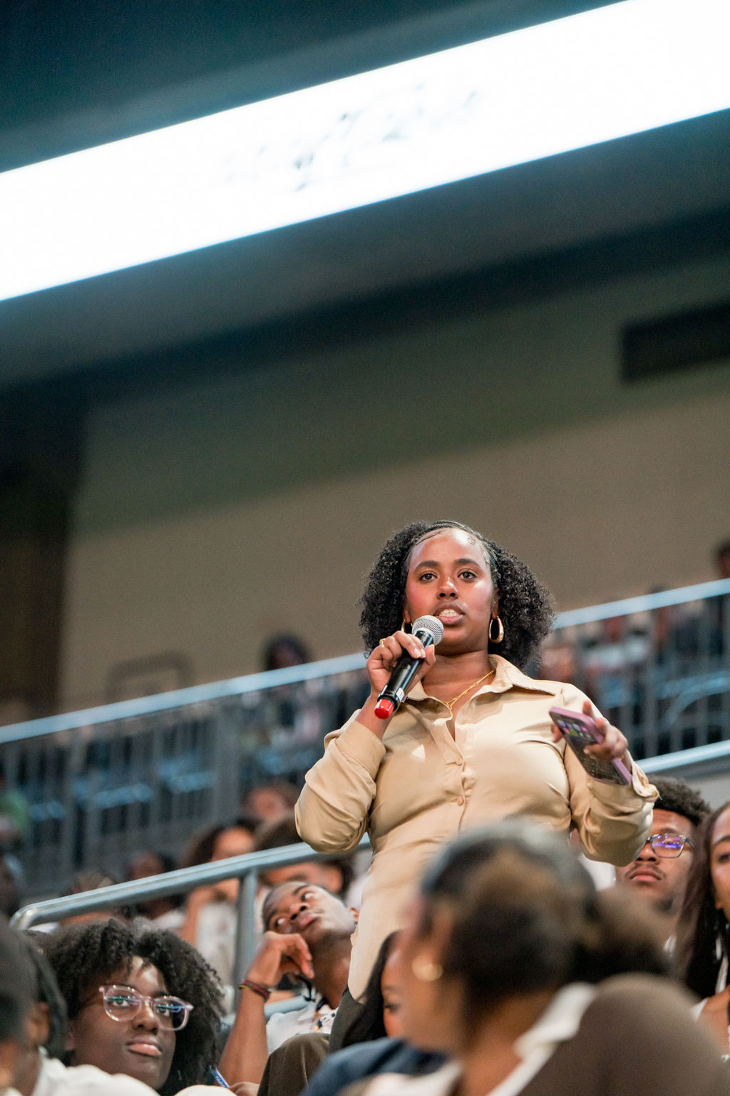 Student-athlete asking a question from the stands