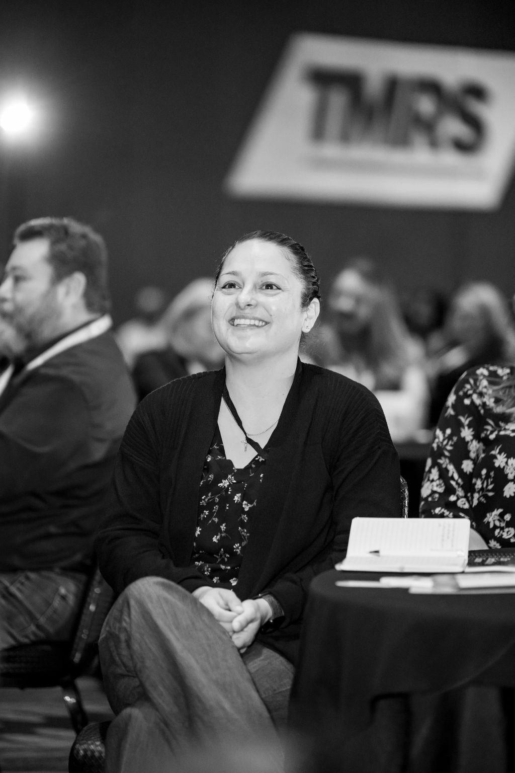 Black and white portrait of an attendee smiling during a session