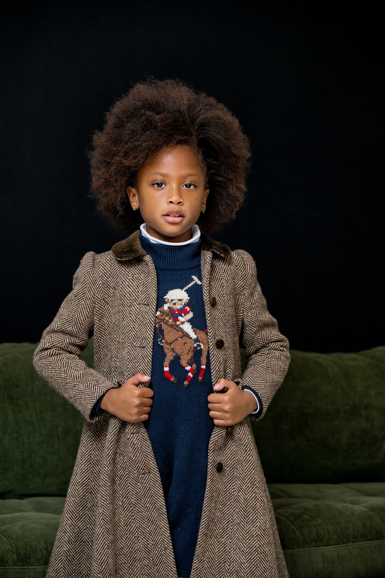 Editorial portrait of a young model in a tailored herringbone coat
