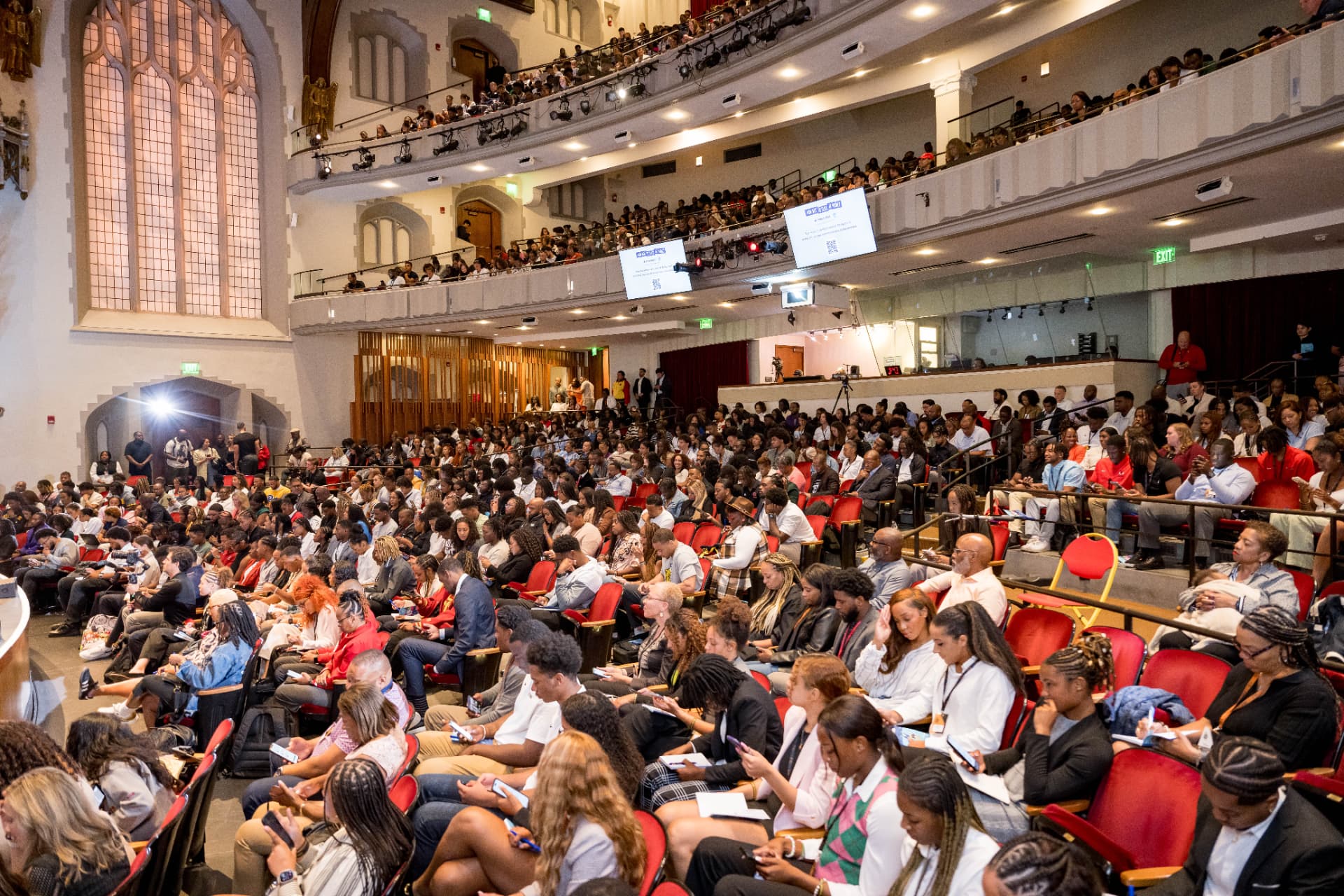 Large audience seated in a grand theater for a conference keynote session
