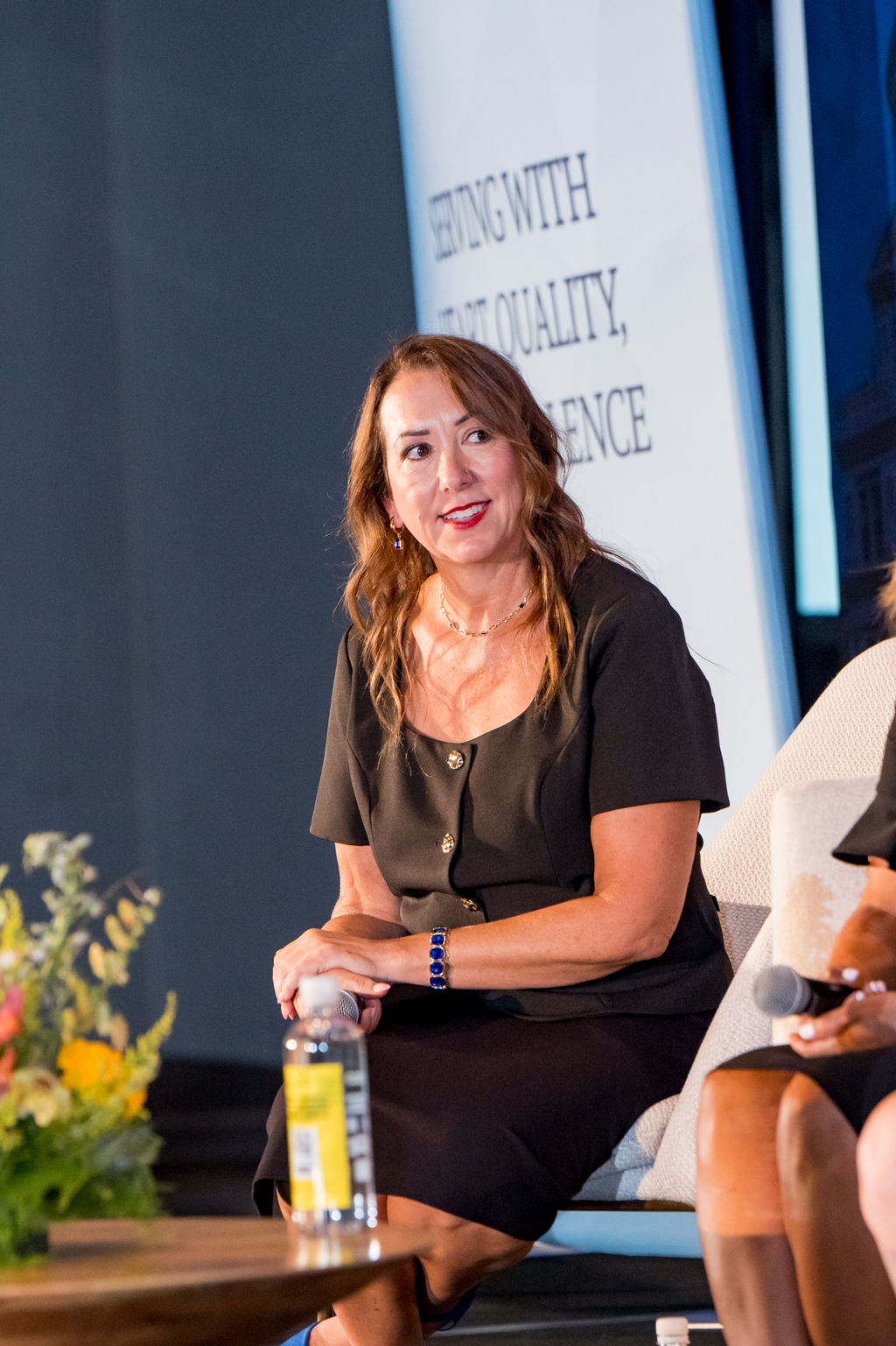 Panelist smiling during a TMRS stage conversation