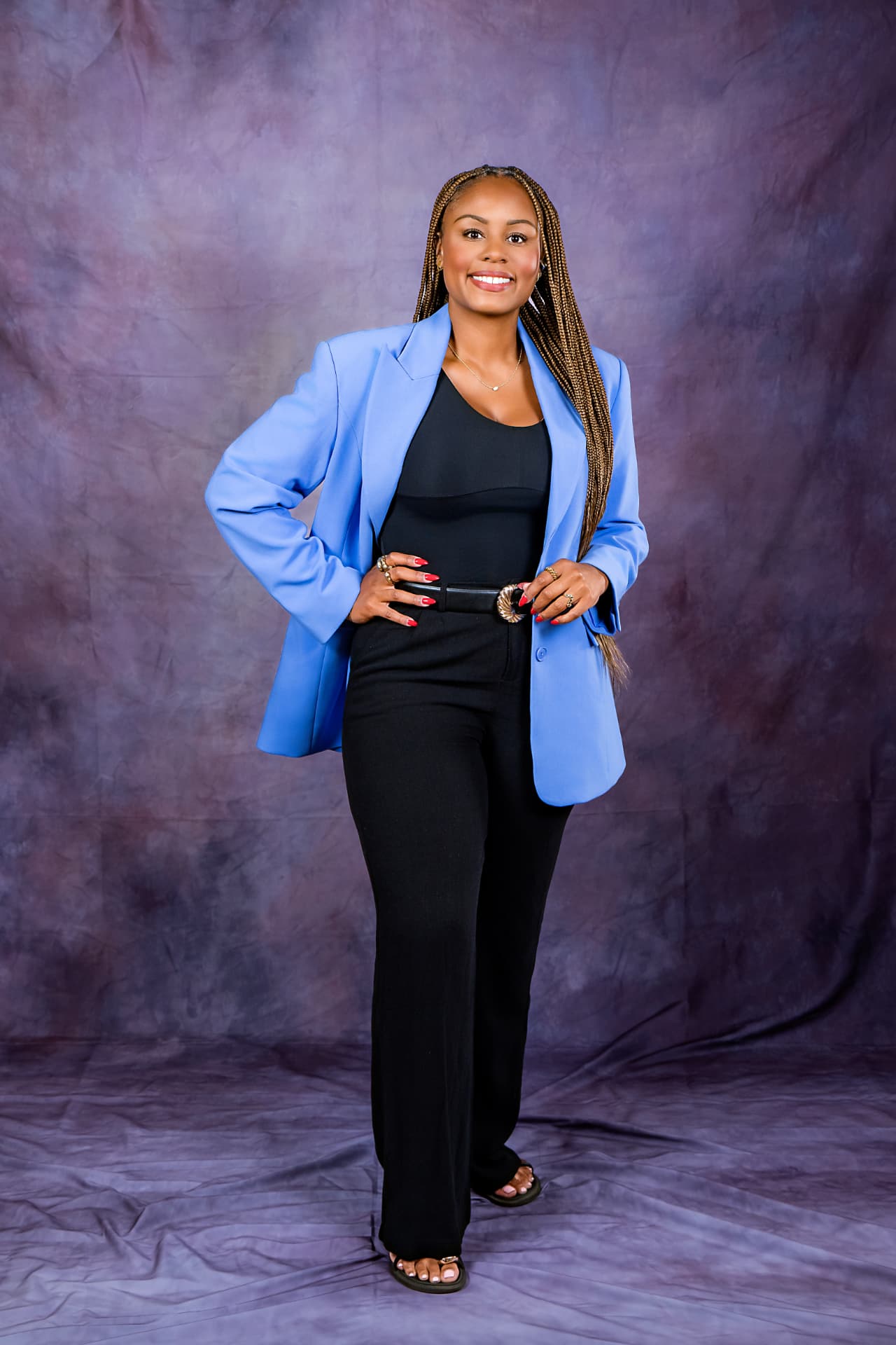 Full-length studio portrait of a woman in a light blue blazer