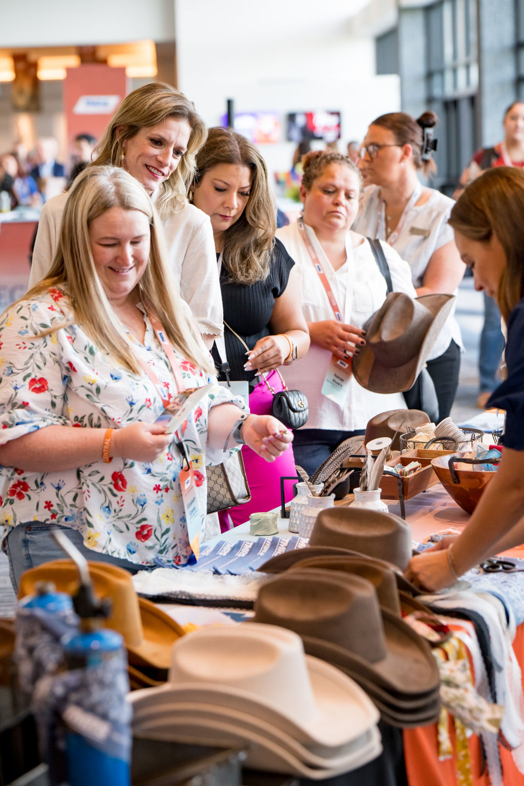 Attendees browsing a Texas hat and gift activation at the conference