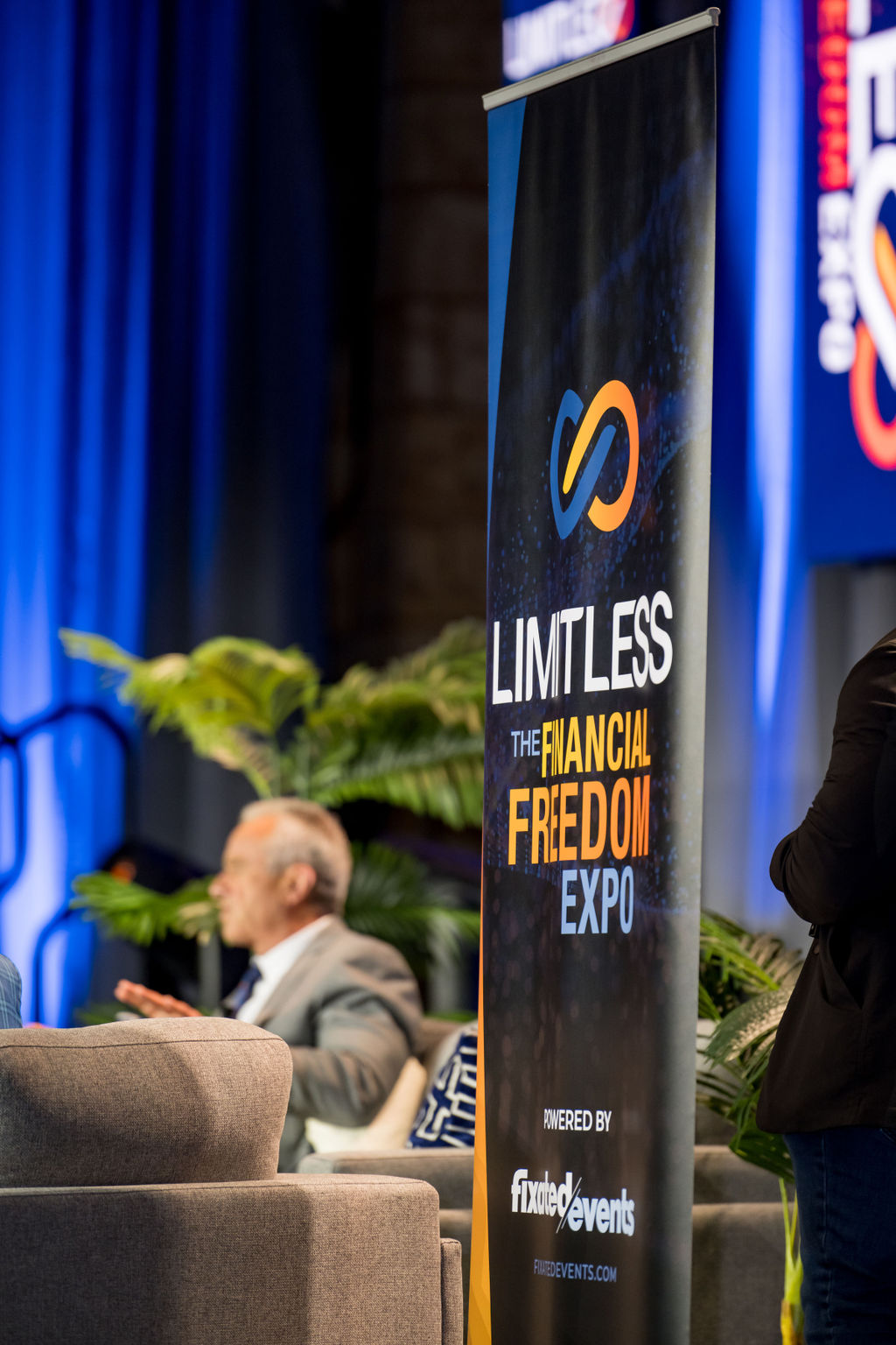 Limitless Financial Freedom Expo banner beside the main stage