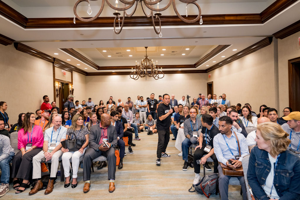 Presenter walking the aisle of a full breakout room at Limitless Expo