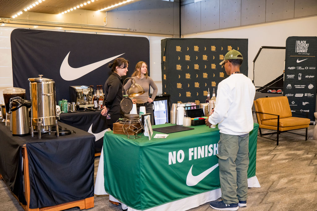Attendee chatting with baristas at the Nike coffee bar