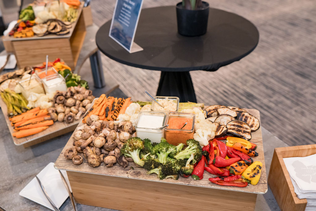 Close detail of grilled vegetables and dips on the conference catering board