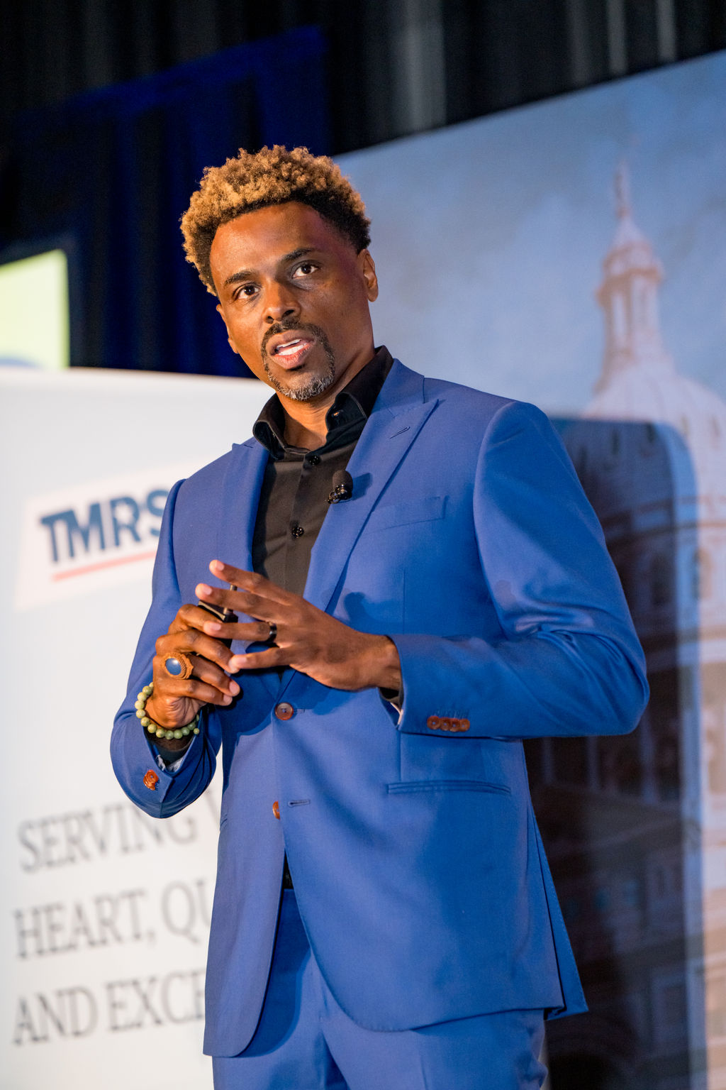 Keynote speaker in a blue suit speaking to the TMRS audience