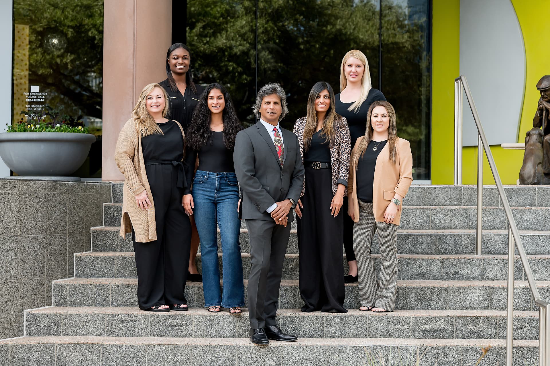 Team group photo posed on office building steps