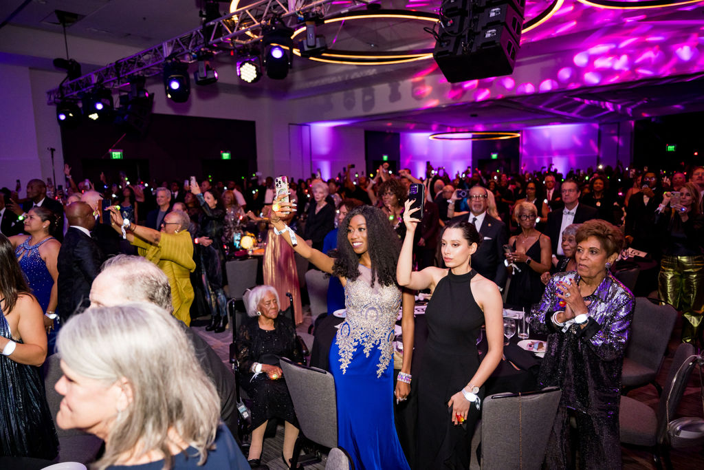 Guests raising phones during a highlight moment