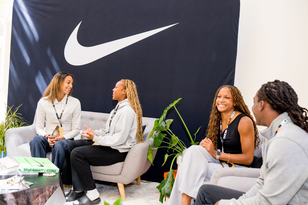 Student athletes chatting in the Nike lounge at the BSA Summit