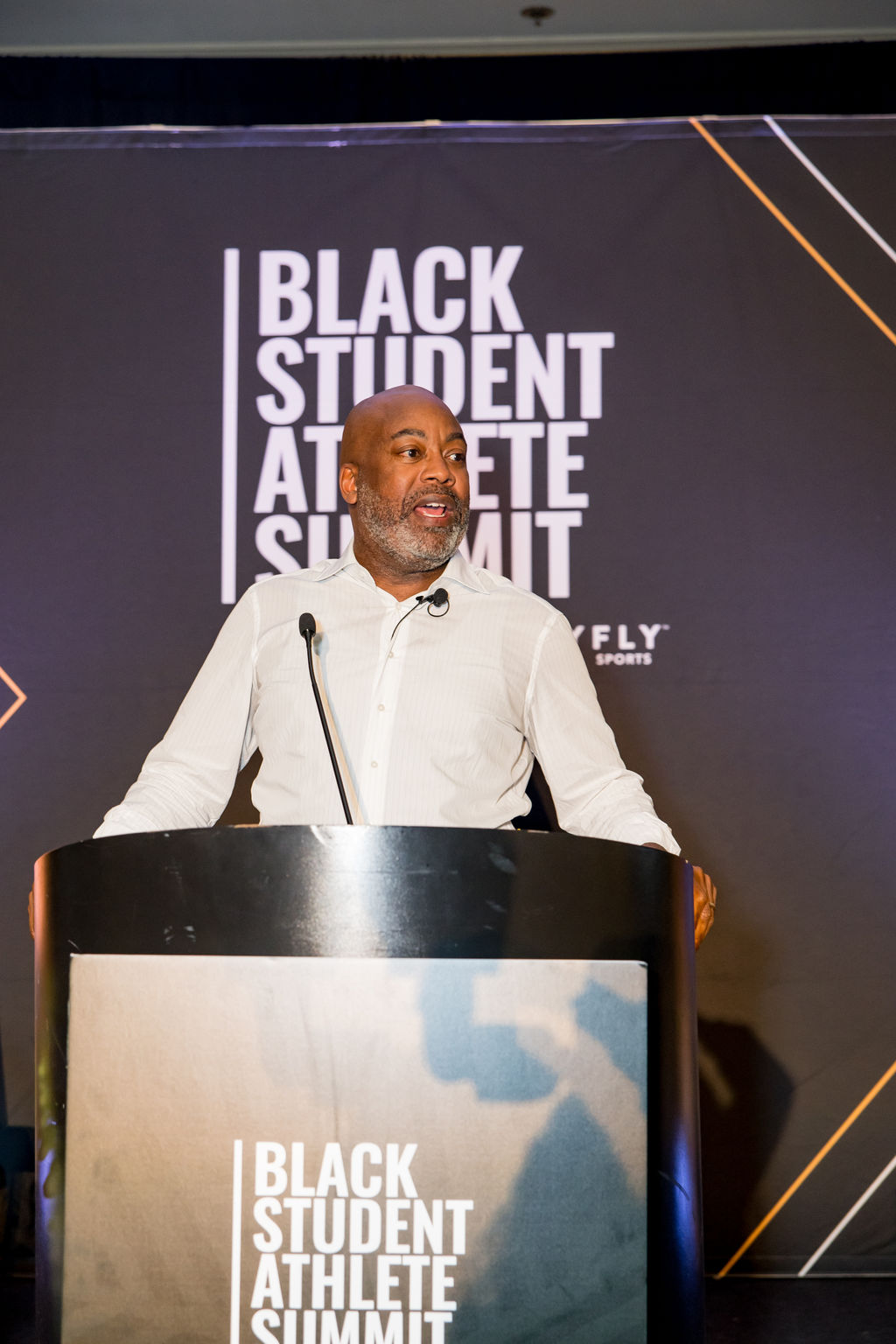Leader delivering remarks from the summit podium
