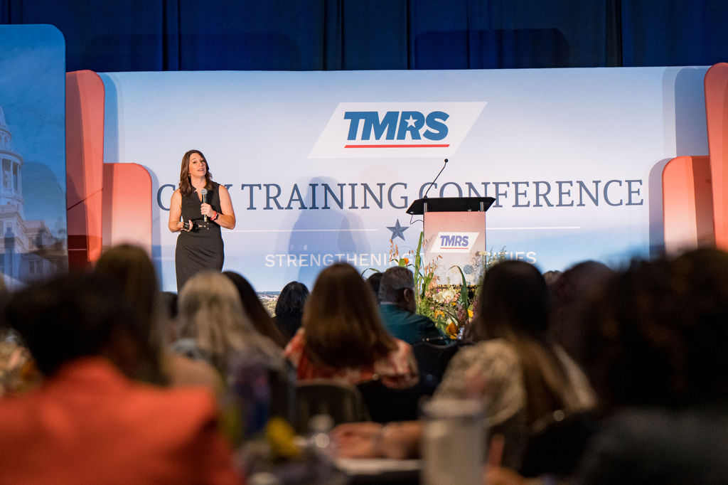 Presenter on the TMRS City Training Conference stage seen over the audience