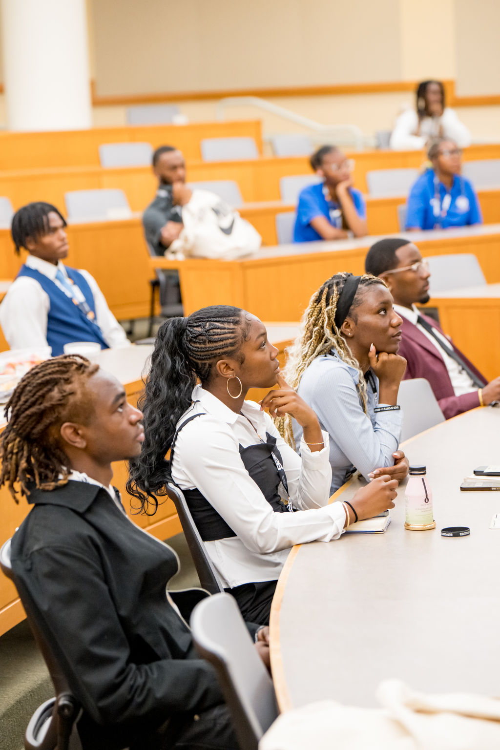 Student athletes listening intently during a breakout session