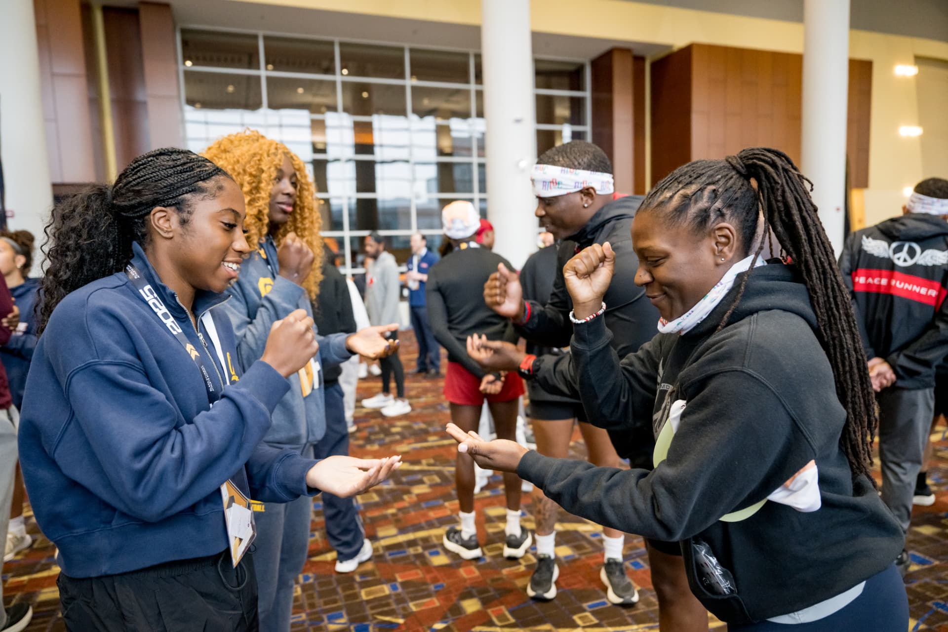 Attendees laughing during a partner warm-up exercise