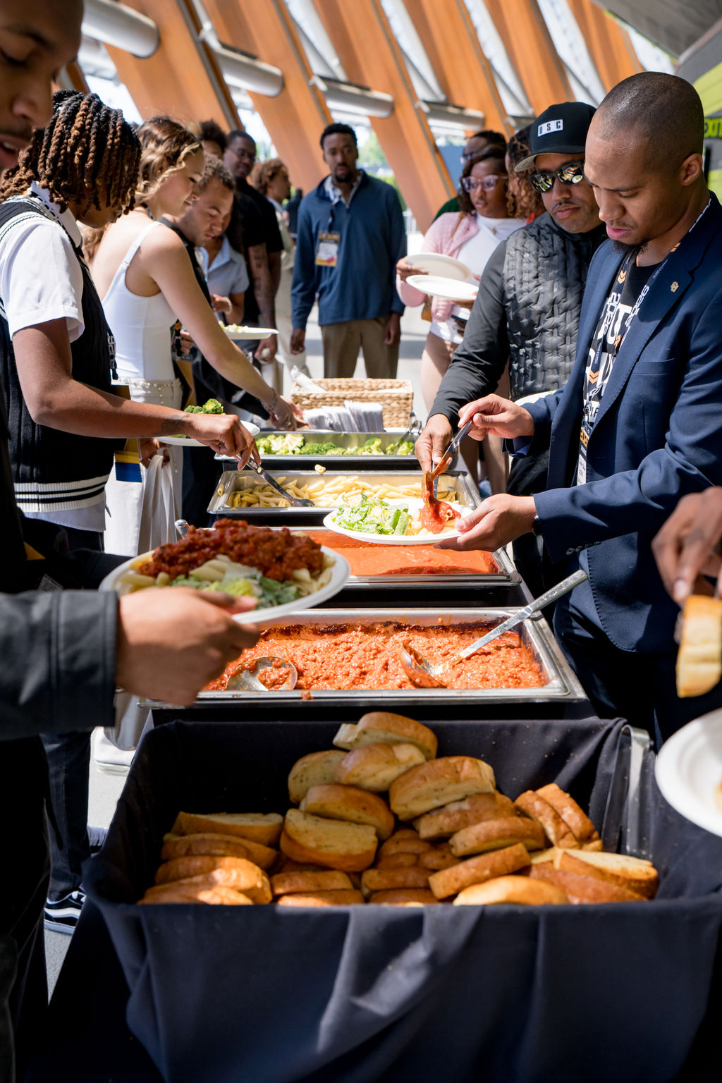 Attendees serving lunch from the catering line