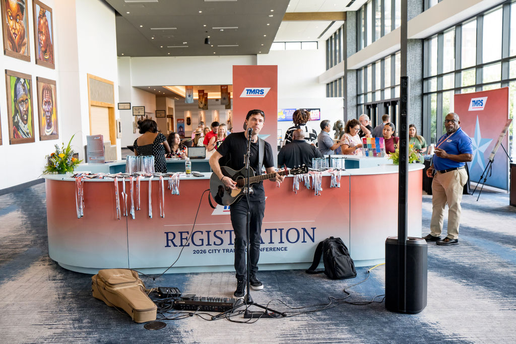 Live acoustic musician performing at the TMRS conference registration desk