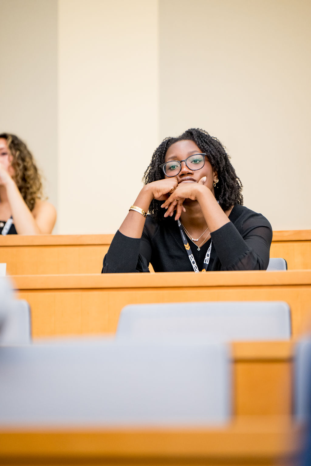Attendee listening intently during a lecture hall session