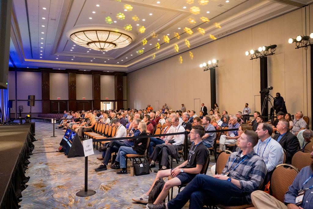 Attendees seated in the VIP section during a Limitless Expo session