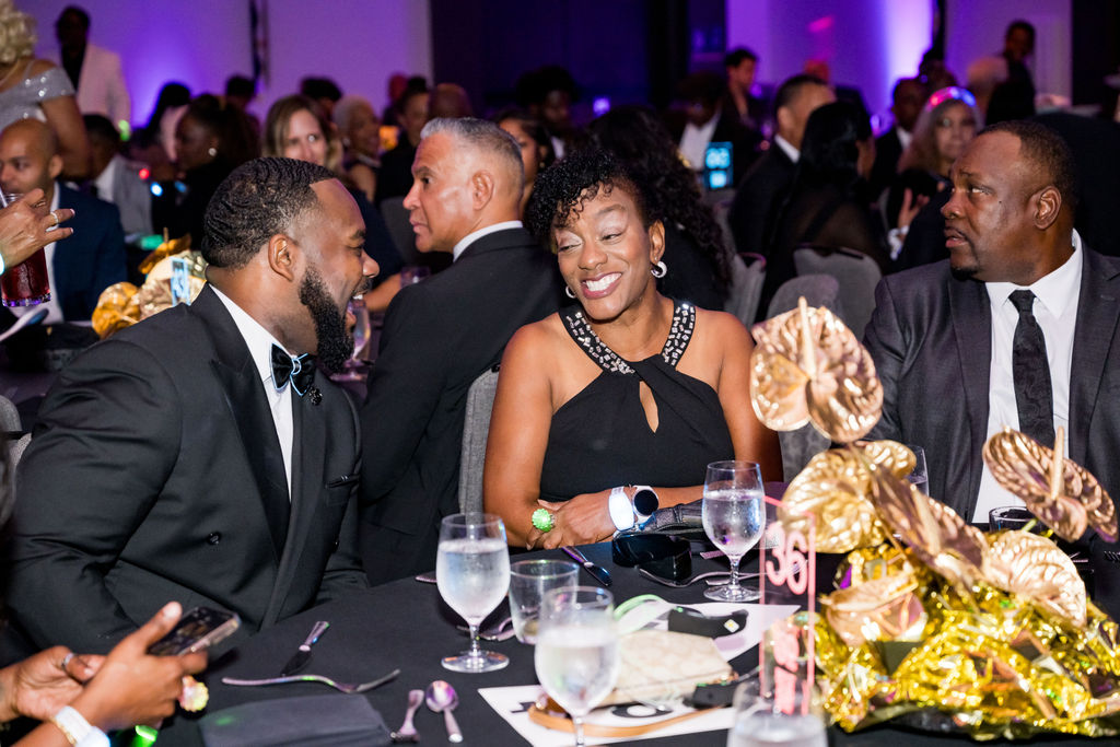 Guests sharing a laugh at their table during dinner