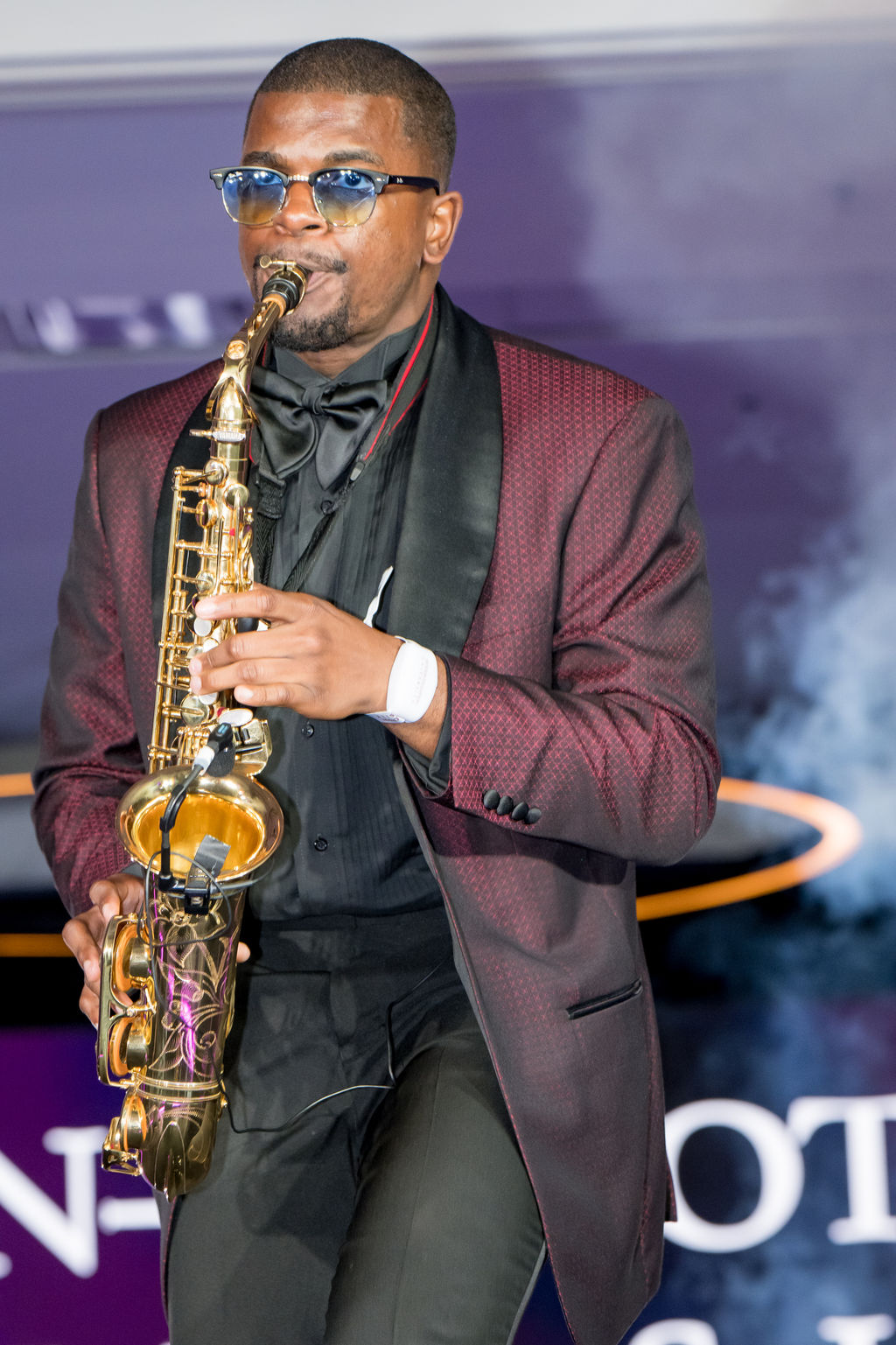 Saxophonist playing a solo under the stage lights