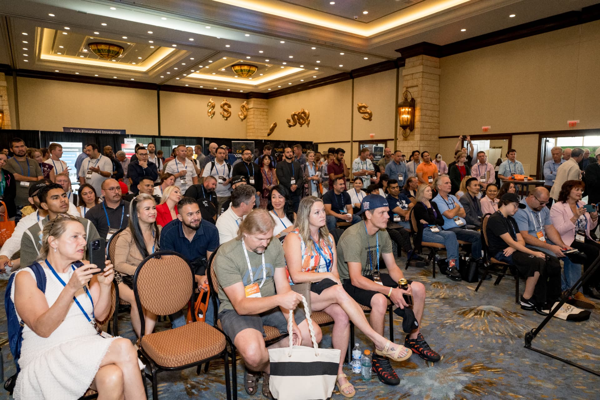Packed ballroom audience watching a session at a business expo