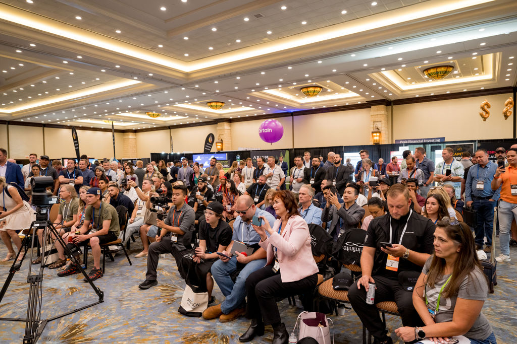 Attendees gathered around a live recording at Limitless Expo